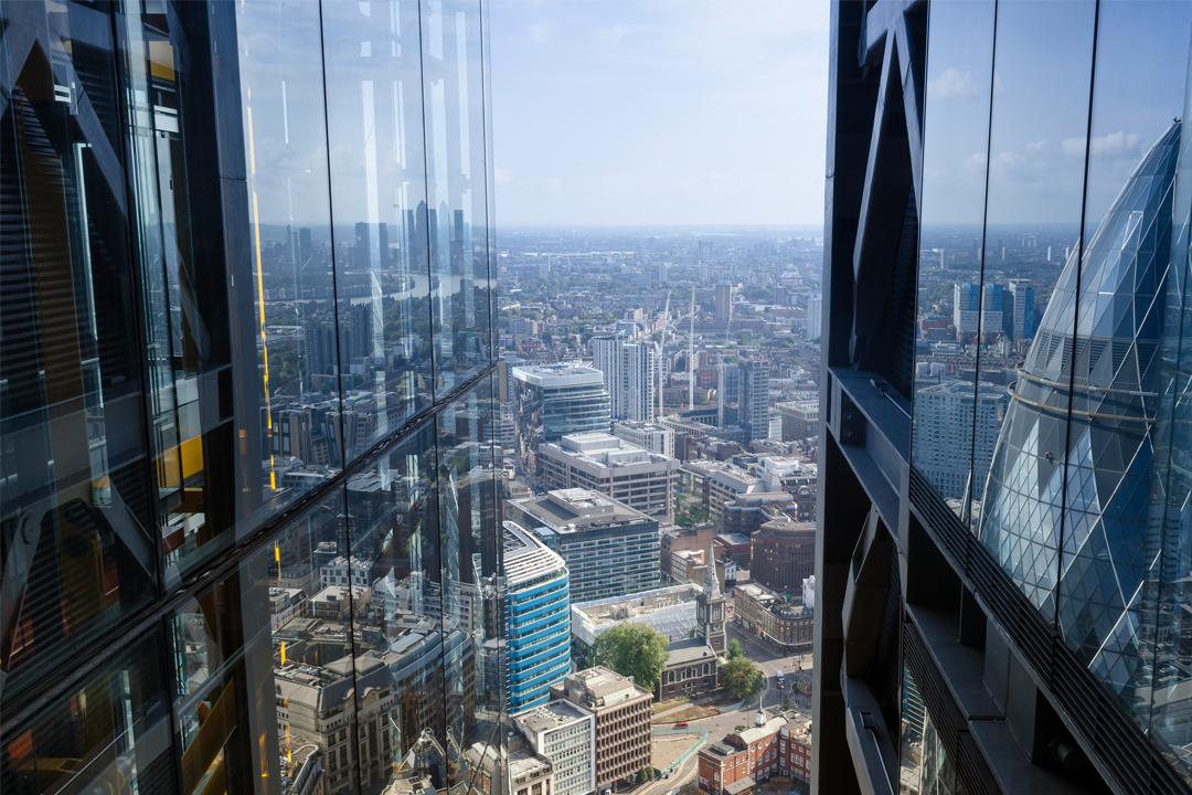 a photo taken from a tall building showing the skyline of london in the daytime
