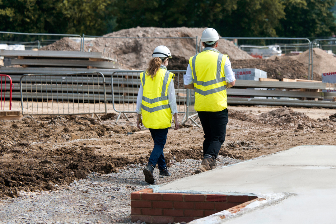 a photo of two people walking on site