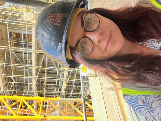 a photo of charlotte harrigan on site in site safety clothing