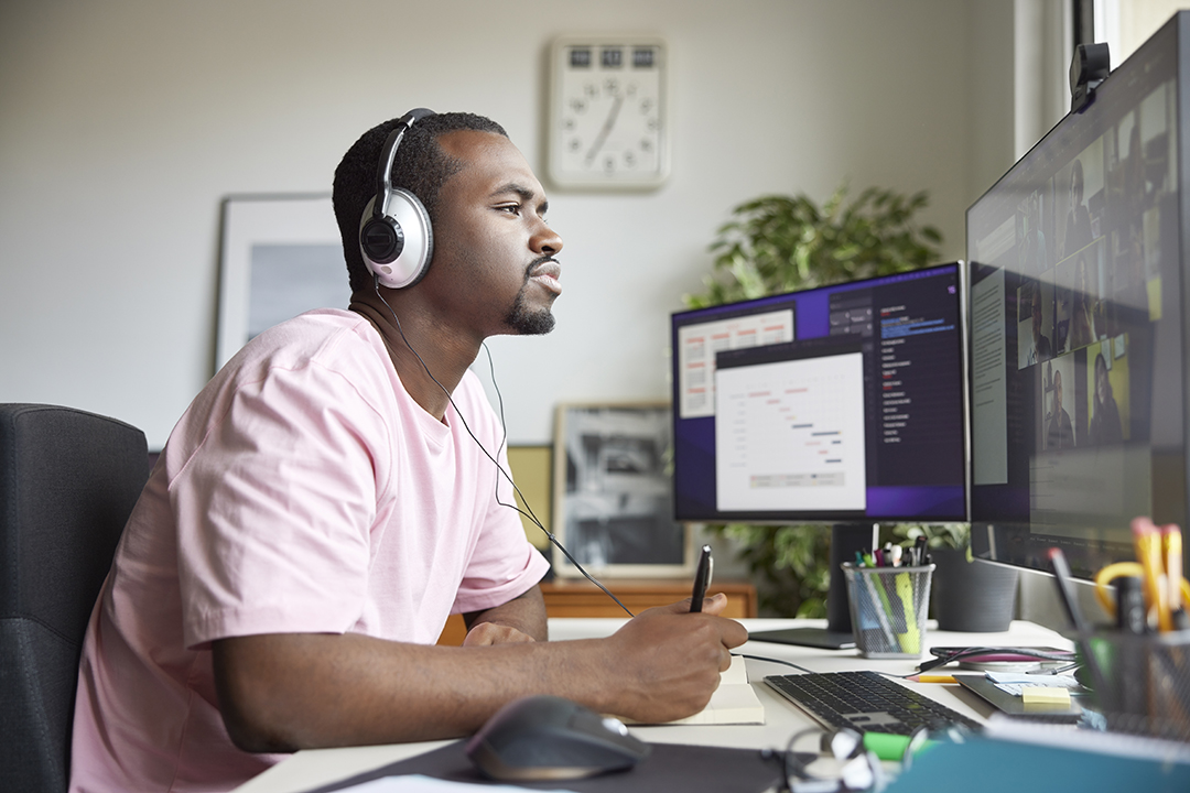 a man wearing headphones sat at a desk