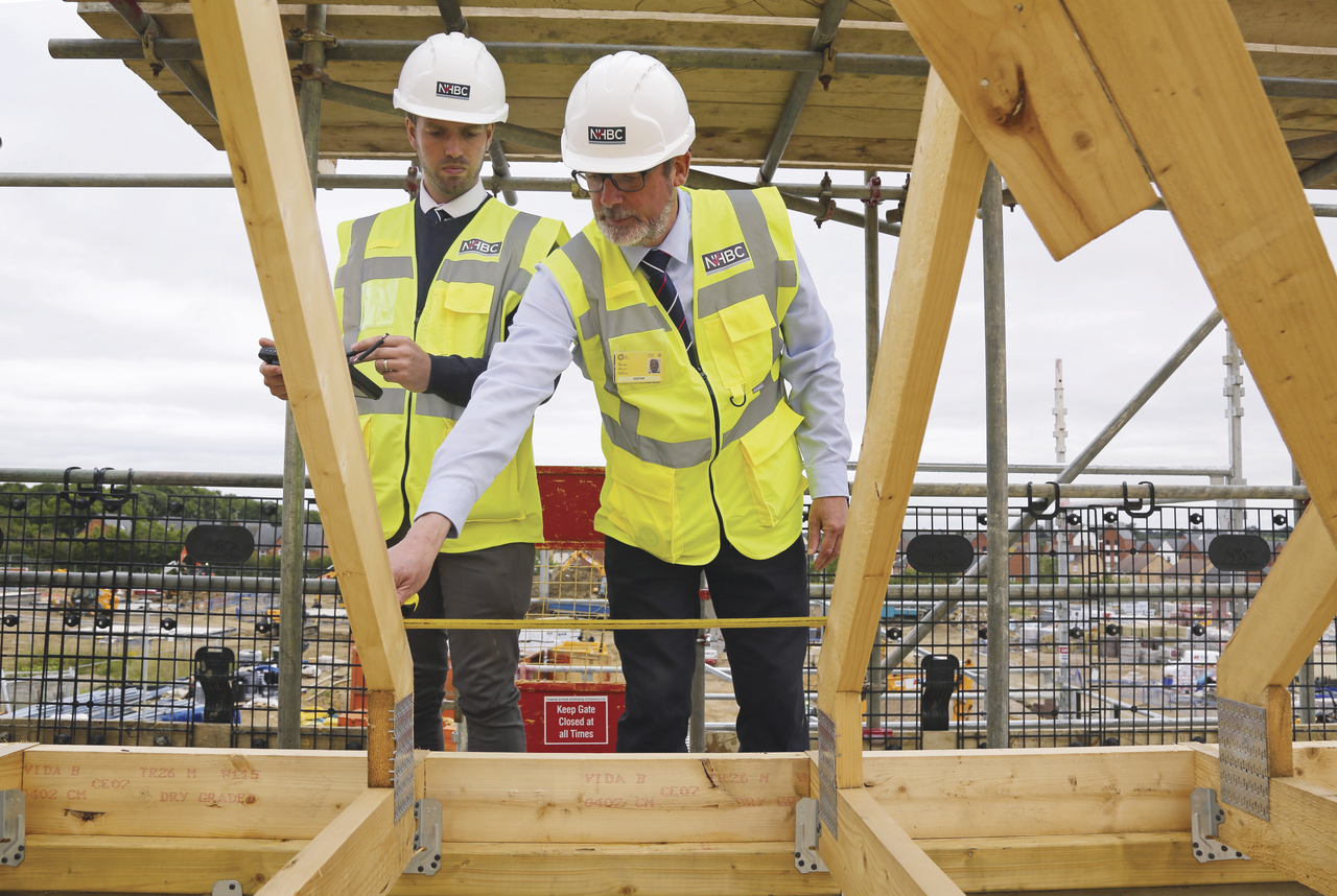 a photo of two people on site wearing site safety clothing