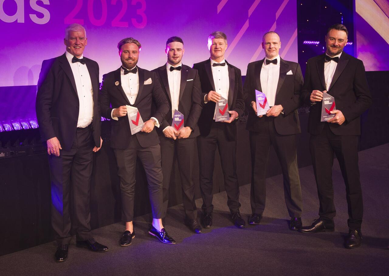 a photo of some winners in suits at the pitj awards