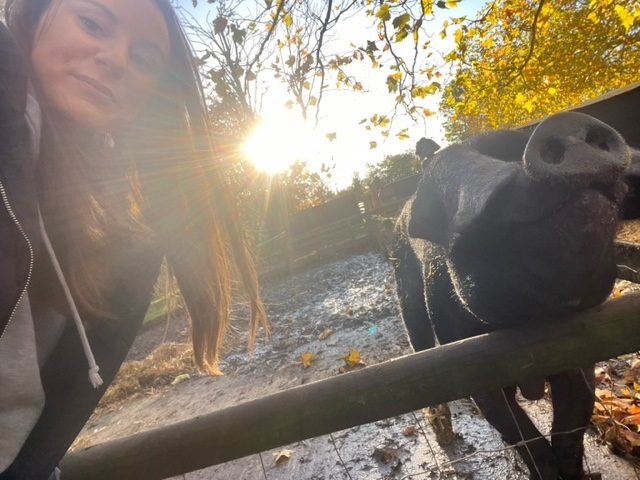 a photo of an nhbc staff member and a pig