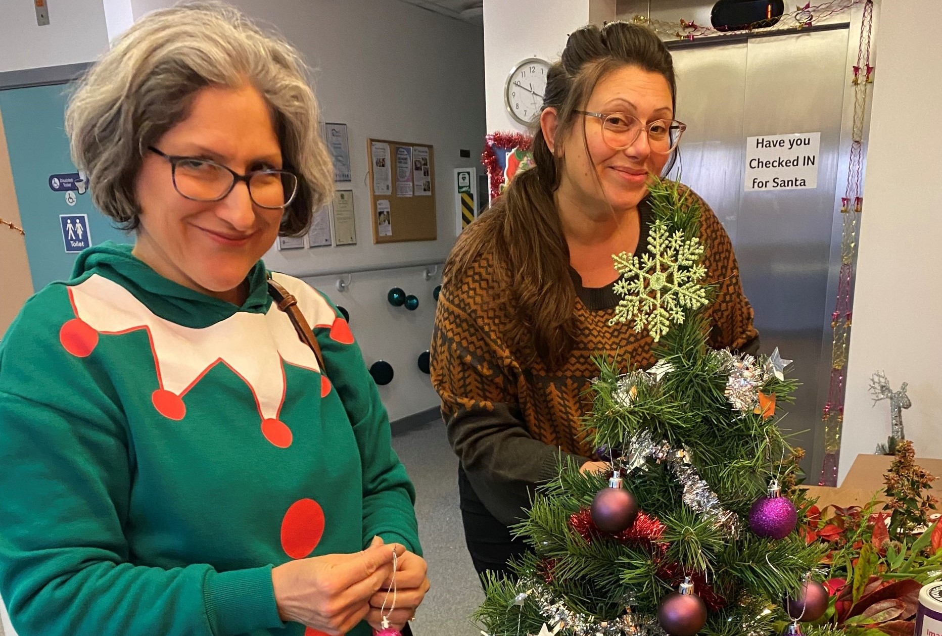 a photo of two nhbc staff members dressed up at christmas