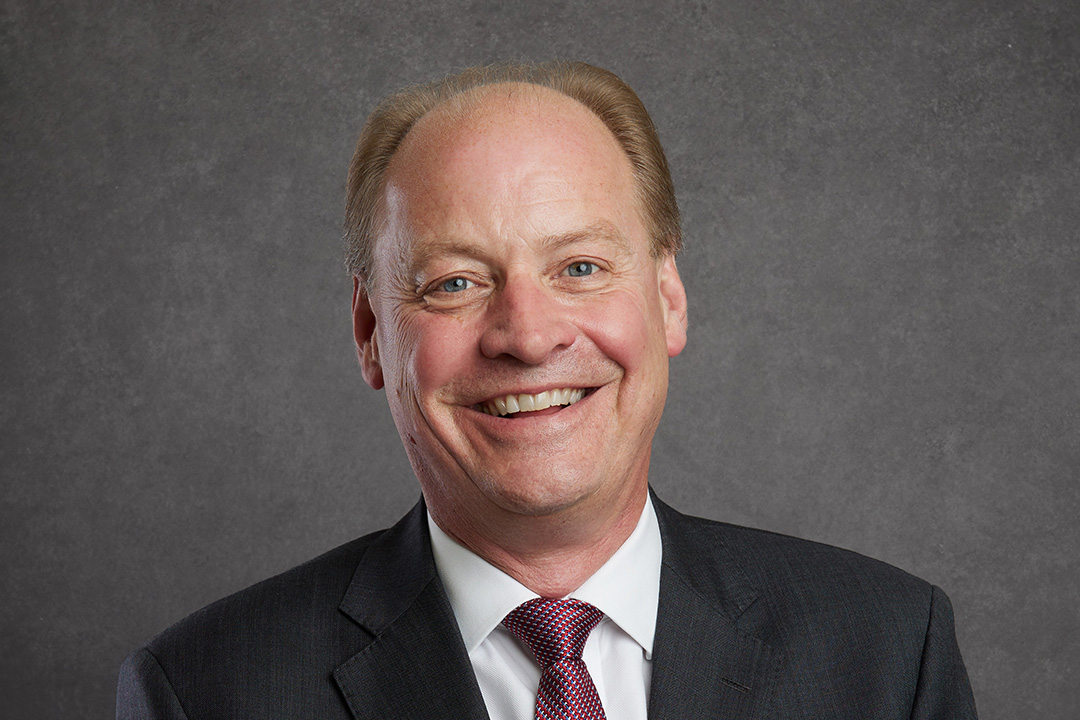 David Campbell, Commercial Director of NHBC, smiling at the camera on a grey background