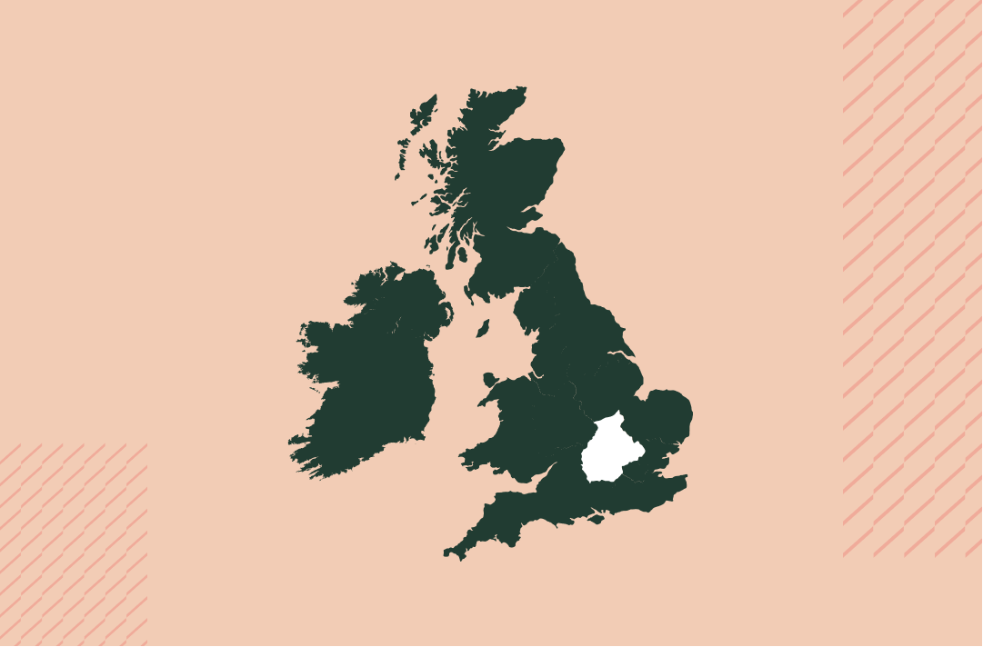 a map of the uk and ireland in navy on a salmon pink background with the central region in white