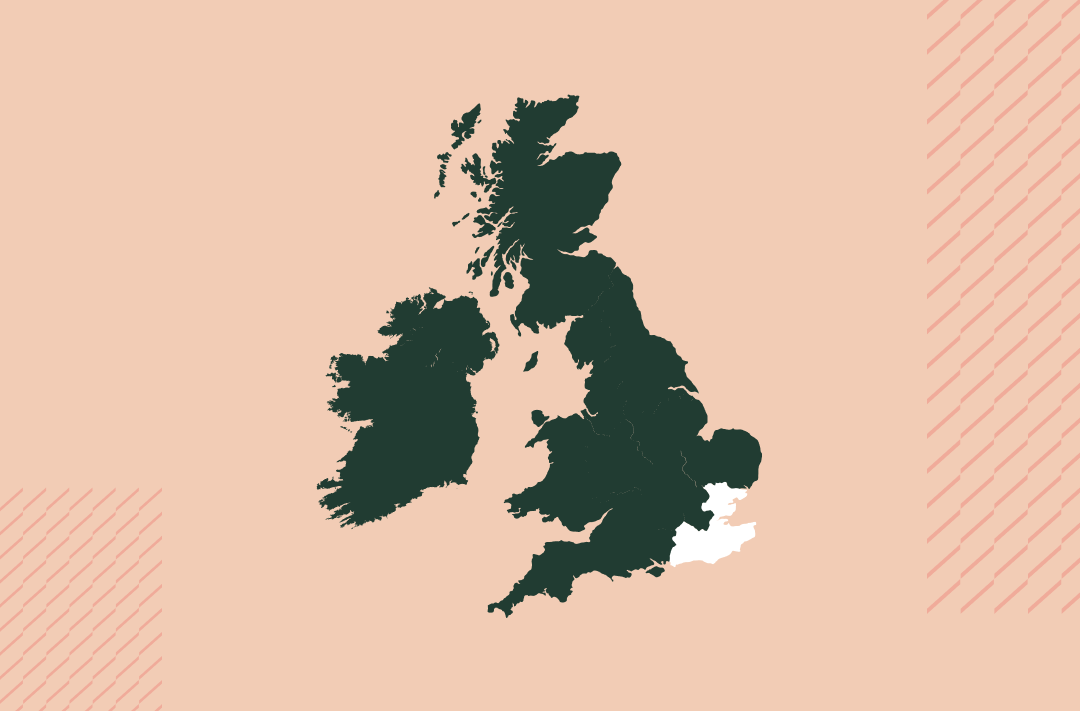 a map of the uk and ireland in navy on a salmon pink background with the south east region in white