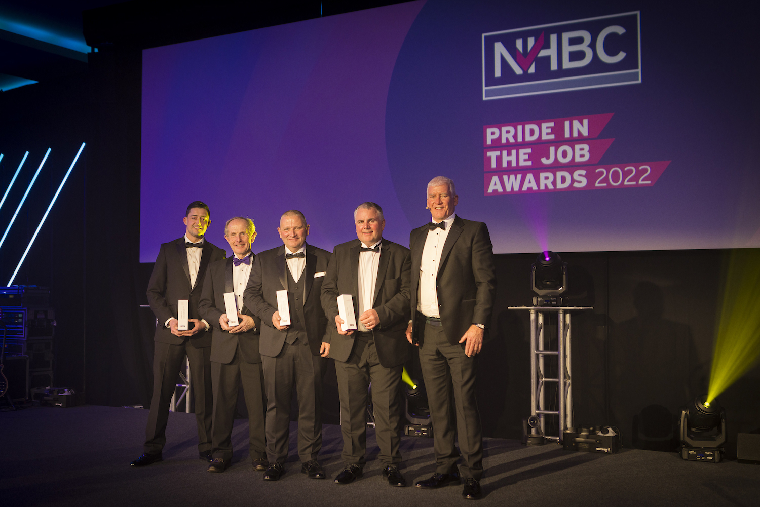 a photo of winners on stage at nhbc's pij awards
