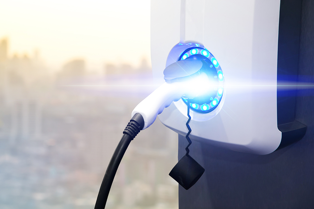 a photo of an electric car charger with a blue flare