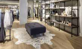 a photo showing a modern clothes shop with industrial style shelving and wooden flooring
