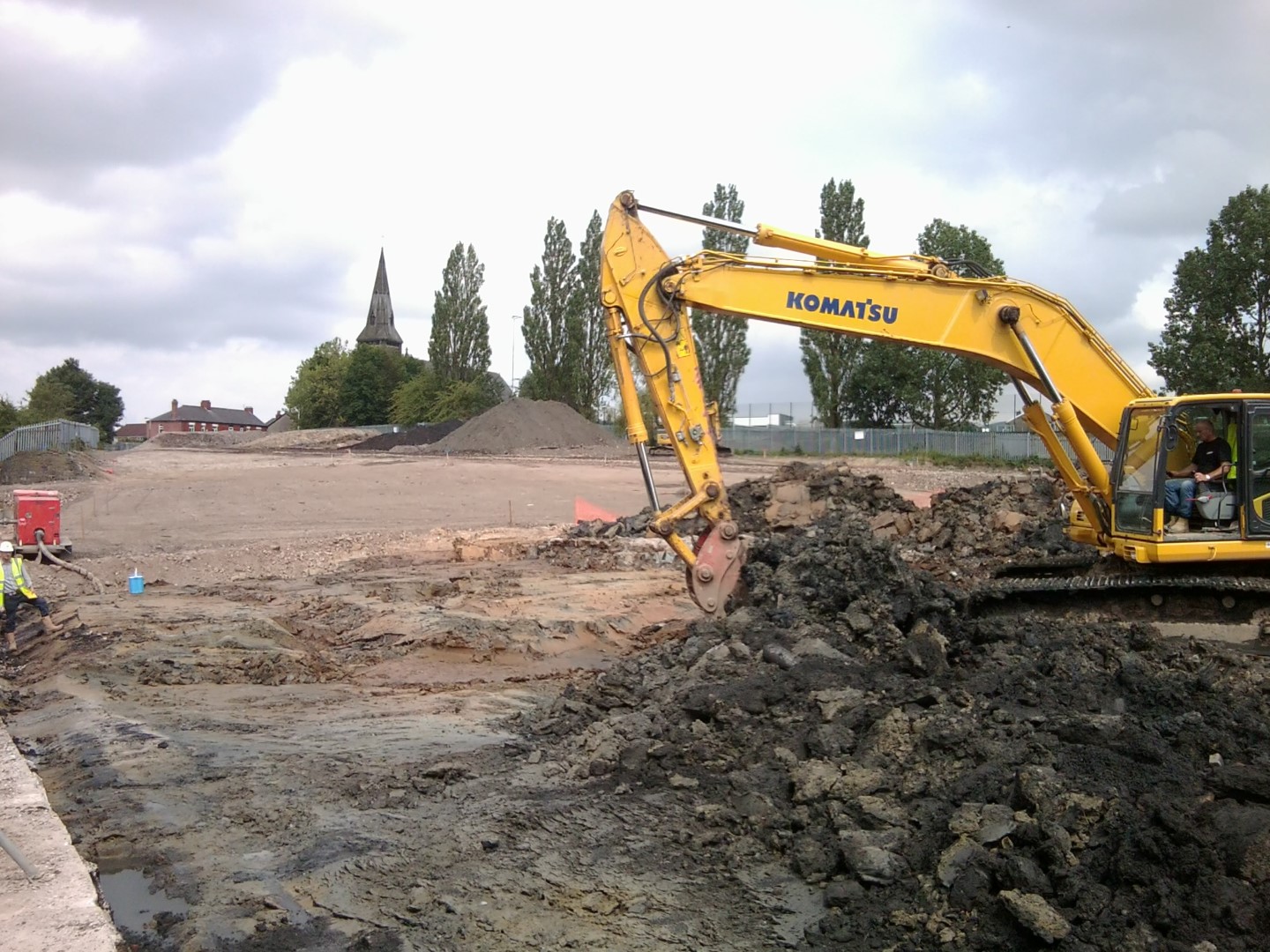 a photo of a digger on site clearing ground for works to begin