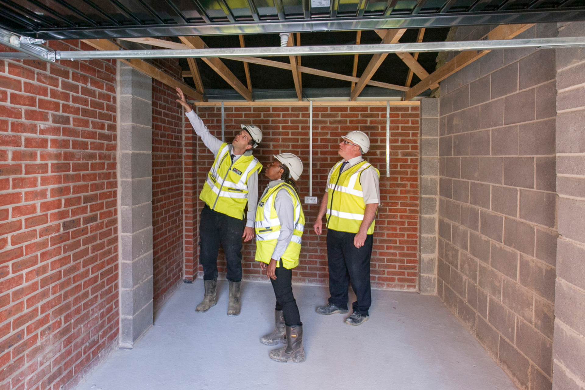 a phot of builders and developers talking on site in site safety clothing