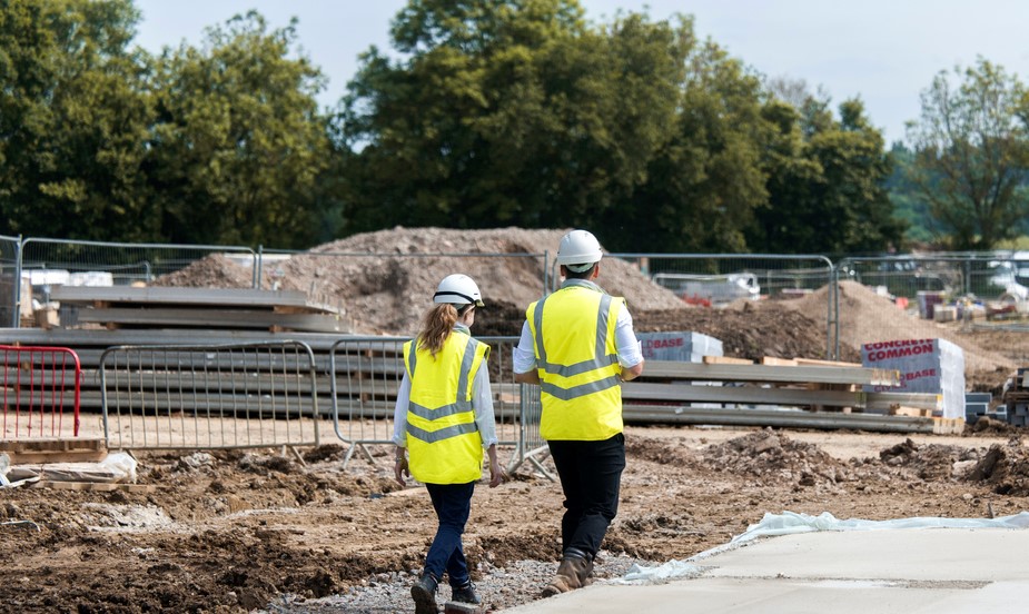 a photo of two people walking on site