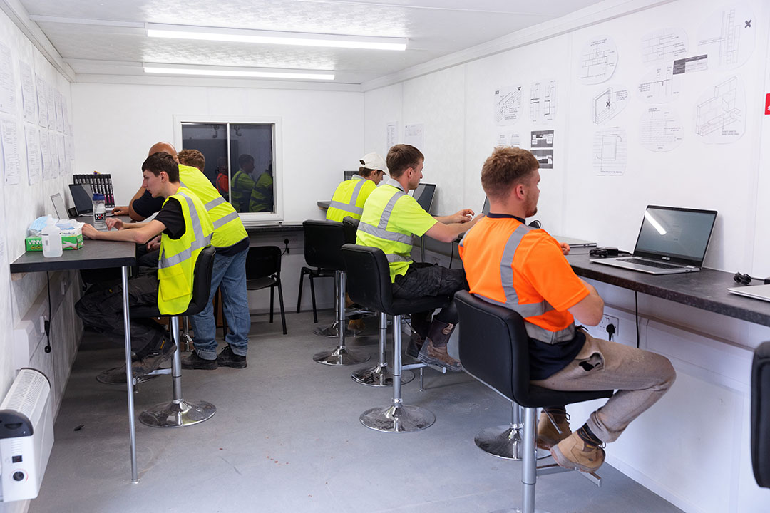 a photo of some apprentices working in an office