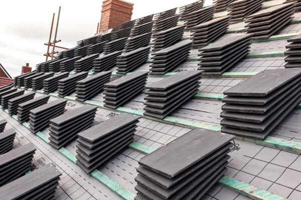 a photo of piles of roof tiles ready to be used on site