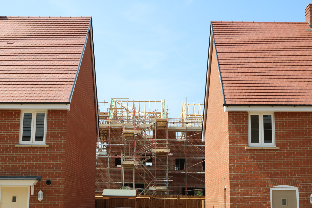 a phoo of two red brick new build houses on an estate