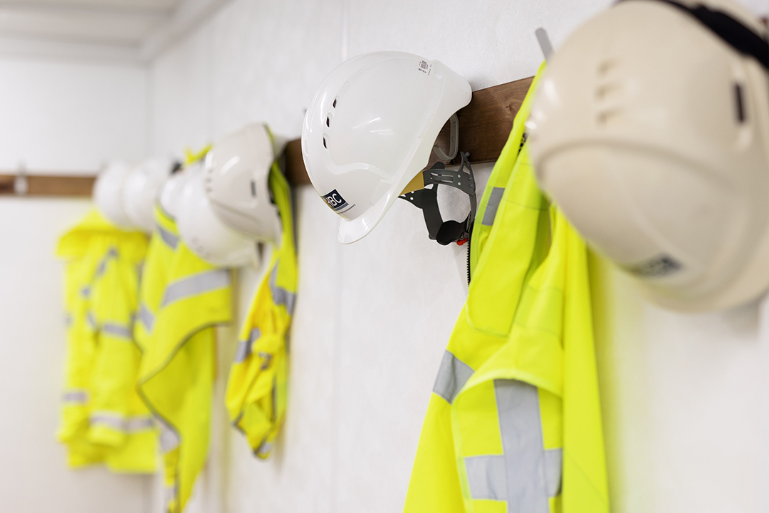 a photo of site safety clothing hanging on a wall
