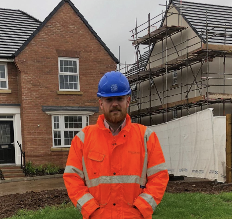 a man on site in site safety clothing looking at the camera