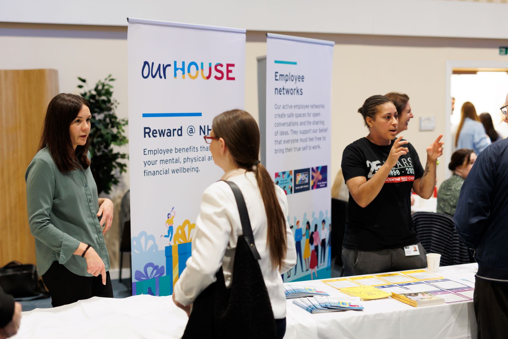 a photo of women at a convention advertising a NHBC scheme