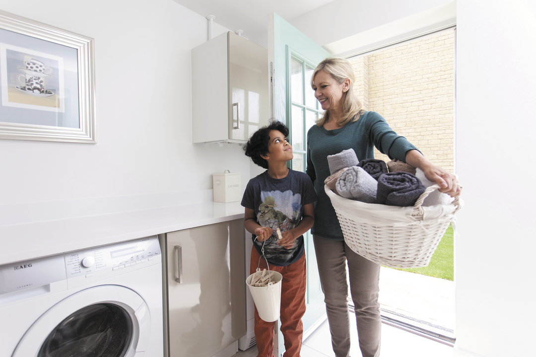 a woman and her son doing laundry in their new home