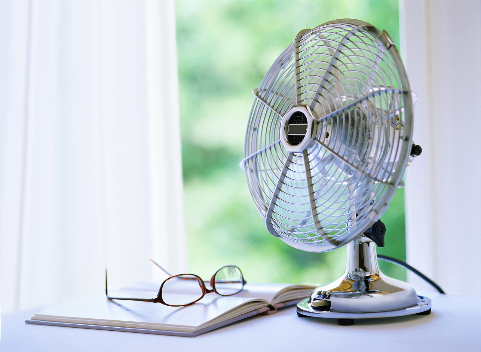 a photo of a fan on a white table