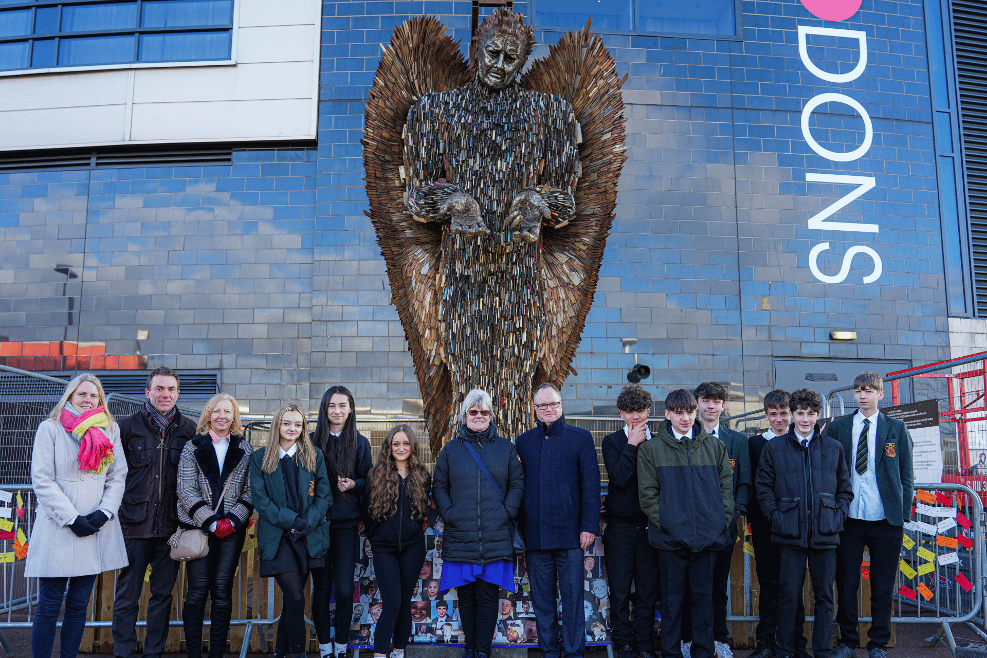 a photo of some nhbc team members in front of the knife angel structure