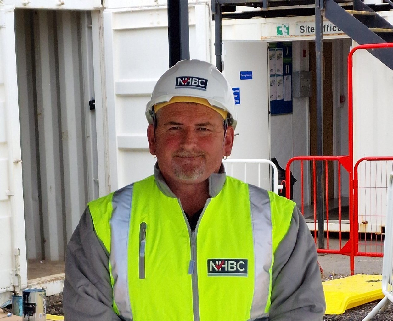 a photo of a man called phill wearing site safety clothing and smiling at the camera