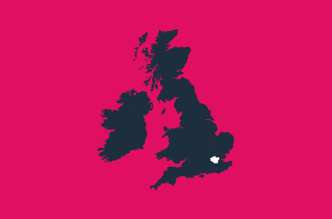 a map of the uk and ireland in navy on a pink background with the london region in white
