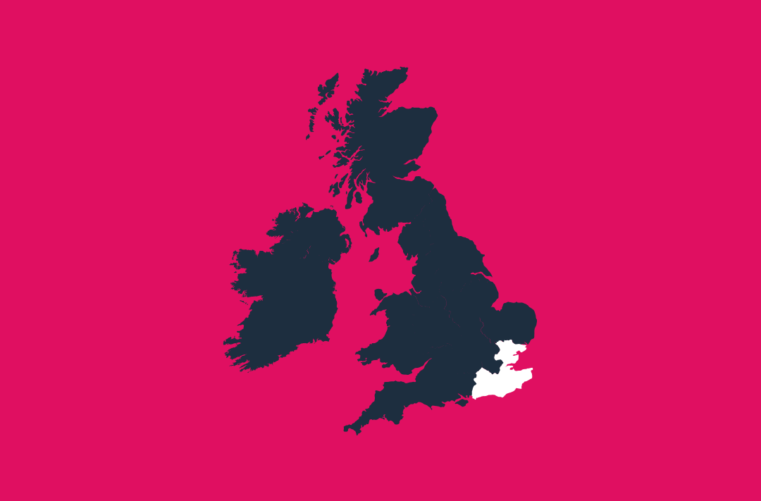 a map of the uk and ireland in navy on a pink background with the south east region in white